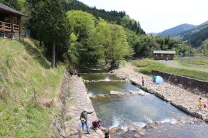 a group of people standing next to a river at Tom sawyer adventuer village - Vacation STAY 55798v in Mimasaka