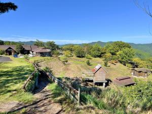 a small house on a hill next to a river at Uenodai Midorinomura - Vacation STAY 33460v in Yasugi +12 photos