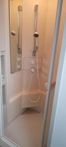a shower in a bathroom with a mirror at Uenodai Midorinomura - Vacation STAY 33458v in Yasugi