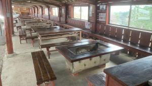 an empty train room with benches and tables at Uenodai Midorinomura - Vacation STAY 27833v in Yasugi