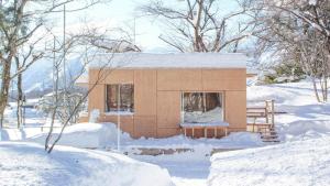 a small house is covered in snow at Snow Peak LAND STATION HAKUBA - Vacation STAY 12869v in Hakuba