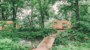a house in the middle of a forest at Snow Peak LAND STATION HAKUBA - Vacation STAY 12869v in Hakuba