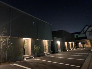 an empty parking lot with a building at night at THE LAND HOTEL - Vacation STAY 16085v in Arao