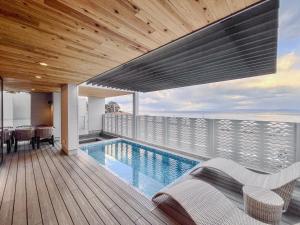 a house with a swimming pool on a balcony at CORAL RESORT VILLA atsuhama - Vacation STAY 21312v in Sumoto