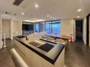 an open kitchen and dining room with a table and chairs at CORAL RESORT VILLA atsuhama - Vacation STAY 21312v in Sumoto