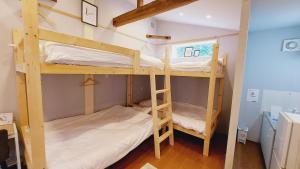 a couple of bunk beds in a small room at Hyuga Surf Camp 101 - Vacation STAY 29178v in Hyuga