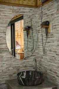 a bathroom with a sink and a mirror at PhouPhet PhouKham Lodge in Louang Namtha +16 photos