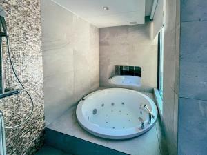 a bath tub in a bathroom with a sink at CORAL RESORT VILLA atsuhama - Vacation STAY 21316v in Sumoto