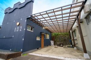 a blue building with a pergola on it at Hyuga Surf Camp102 - Vacation STAY 31830v in Hyuga