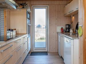 a kitchen with a door leading to a yard at 4 star holiday home in Lemvig in Ferring