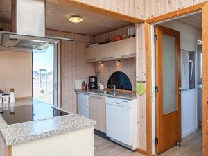 a kitchen with a counter top in a tiny house at 4 star holiday home in Lemvig in Ferring +20 photos