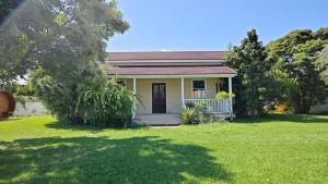a small yellow house with a grass yard at Cardiff-Kujukuri- - Vacation STAY 48763v in Kujukuri