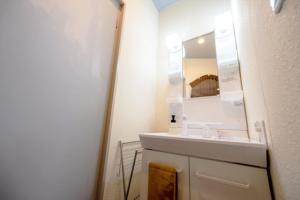 a bathroom with a sink and a mirror at Hyuga Surf Camp 212 - Vacation STAY 35446v in Hyuga +13 photos