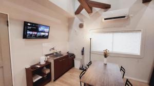 a kitchen and dining room with a table and a window at Hyuga Surf Camp 210 - Vacation STAY 35366v in Hyuga