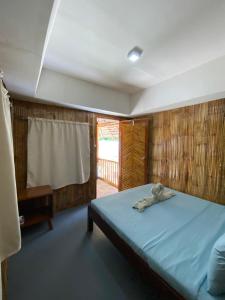 a bedroom with a bed with a stuffed animal on it at Moalboal Beach Front Hotel in Moalboal