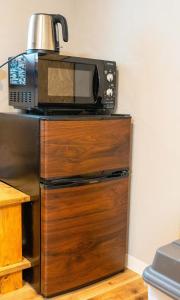 a microwave sitting on top of a wooden dresser at Hyuga Surf Camp112 - Vacation STAY 31765v in Hyuga +13 photos