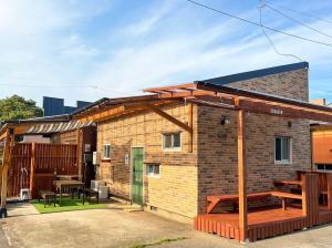 a brick house with a deck and a patio at Hyuga Surf Camp112 - Vacation STAY 31765v in Hyuga