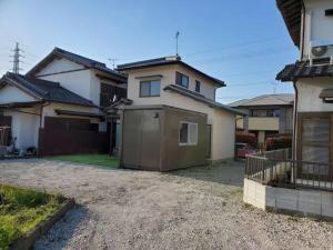 a house with a garage in the driveway at Guest House Wakamizu - Vacation STAY 18625 in Koga
