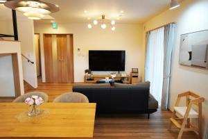 a living room with a couch and a tv at Hikarinoyado Yamate - Vacation STAY 18639 in Sasebo