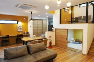 a living room with a couch and a dining room at Hikarinoyado Yamate - Vacation STAY 18639 in Sasebo