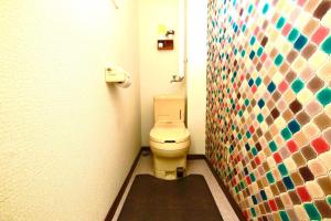 a bathroom with a toilet and a mosaic wall at Sharm East - Vacation STAY 45456v in Kushiro +20 photos