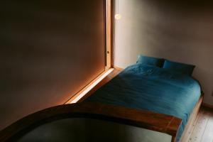 a small bed in a room with a window at Nagominonedoko - Vacation STAY 48069v in Nishinoomote