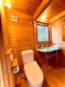 a bathroom with a toilet and a sink in a cabin at Gubo Satoyama Suite Lodge & Camp - Vacation STAY 39510v in Katsuura