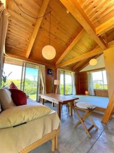 a room with a bed and a table and windows at Gubo Satoyama Suite Lodge & Camp - Vacation STAY 39505v in Katsuura
