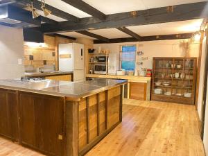 a large kitchen with a large island in the middle at La Cachette - Vacation STAY 45323v in Ina