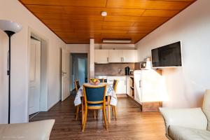 a kitchen and living room with a table and chairs at Ferienhaus Vier Jahreszeiten in Frauenwald