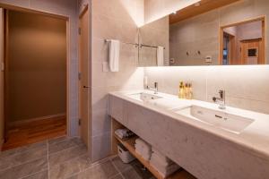 a bathroom with two sinks and a large mirror at Miyabi Sengokuhara Hot Spring Villa - Vacation STAY 60344v in Sengokuhara +26 photos
