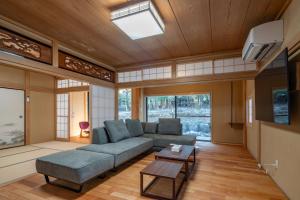 a living room with a couch and a tv at Miyabi Sengokuhara Hot Spring Villa - Vacation STAY 60344v in Sengokuhara
