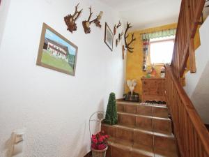 a hallway with stairs with a picture on the wall at Apartment in Fügenberg near Ski Slopes in Fügenberg +25 photos