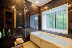 a bathroom with a tub and a window at RIN - Vacation STAY 71992v in To-katta +24 photos