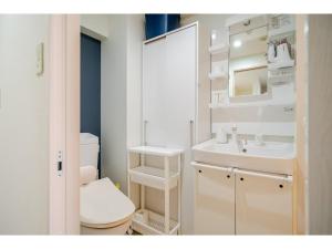 a bathroom with a toilet and a sink and a mirror at Yellow Submarine - Vacation STAY 72738v in Naha +11 photos