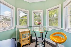 a dining room with green walls and windows at Charming Victorian Home with Porch & Large Yard home in Catonsville