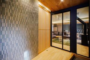 a living room with a brick wall and glass doors at Sunlight - Vacation STAY 73377v in To-katta