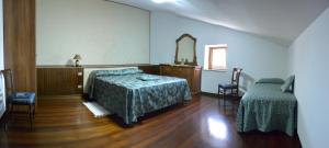 a bedroom with a bed and a dresser and a mirror at Il Gheriglio in Torano Nuovo