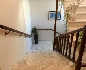 a stairway with a wooden railing and a stair case at Asteri Hotel in Livadi