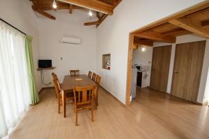 a dining room with a table and chairs at Ryuyo Marine Park Auto Campsite - Vacation STAY 78095v in Kaketsuka +11 photos