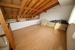 an attic room with a bed and wooden ceilings at Ryuyo Marine Park Auto Campsite - Vacation STAY 78095v in Kaketsuka