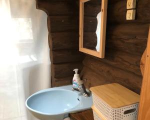 a bathroom with a blue sink and a mirror at Chiisana Loghouse - Vacation STAY 83181v in Goto