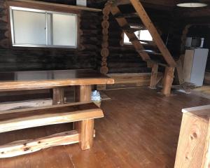 a room with a wooden table and a window at Chiisana Loghouse - Vacation STAY 83181v in Goto