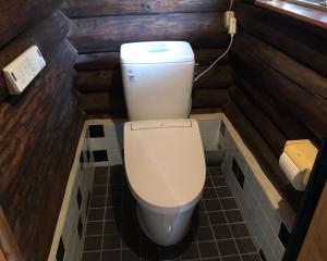 a bathroom with a toilet in a small room at Chiisana Loghouse - Vacation STAY 83181v in Goto +2 photos