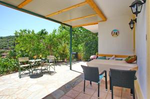 a patio with a table and chairs on a patio at Pelagos in Stafylos