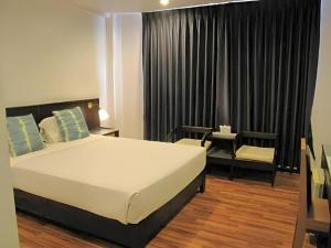 a bedroom with a bed and a desk and a chair at Dusit Hotel in Sakon Nakhon +132 photos