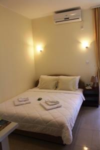 a bedroom with a bed with two towels on it at Swiss Residence Montenegro in Herceg-Novi