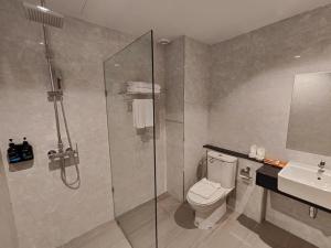 a bathroom with a shower and a toilet and a sink at Butterfly Princess Hotel in Betong +52 photos