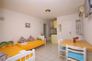 a room with two beds and a table in it at Pelagos in Stafylos
