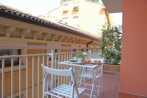 a table and two chairs on a balcony at La Casetta di Lina Rooms and Apartments in Verona